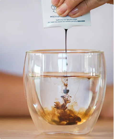 Pouring Manna Vitality into a glass of water
